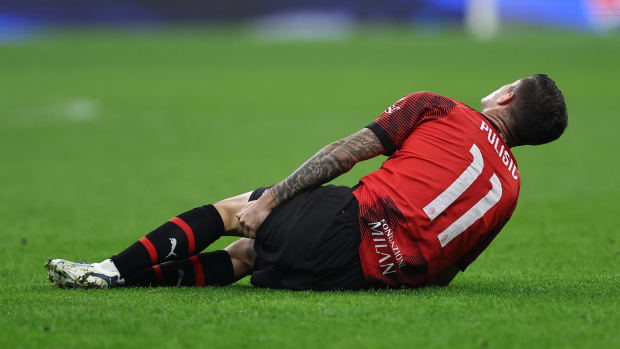 Christian Pulisic pictured holding his left hamstring after suffering an injury blow during AC Milan's 2-1 win over PSG in November 2023